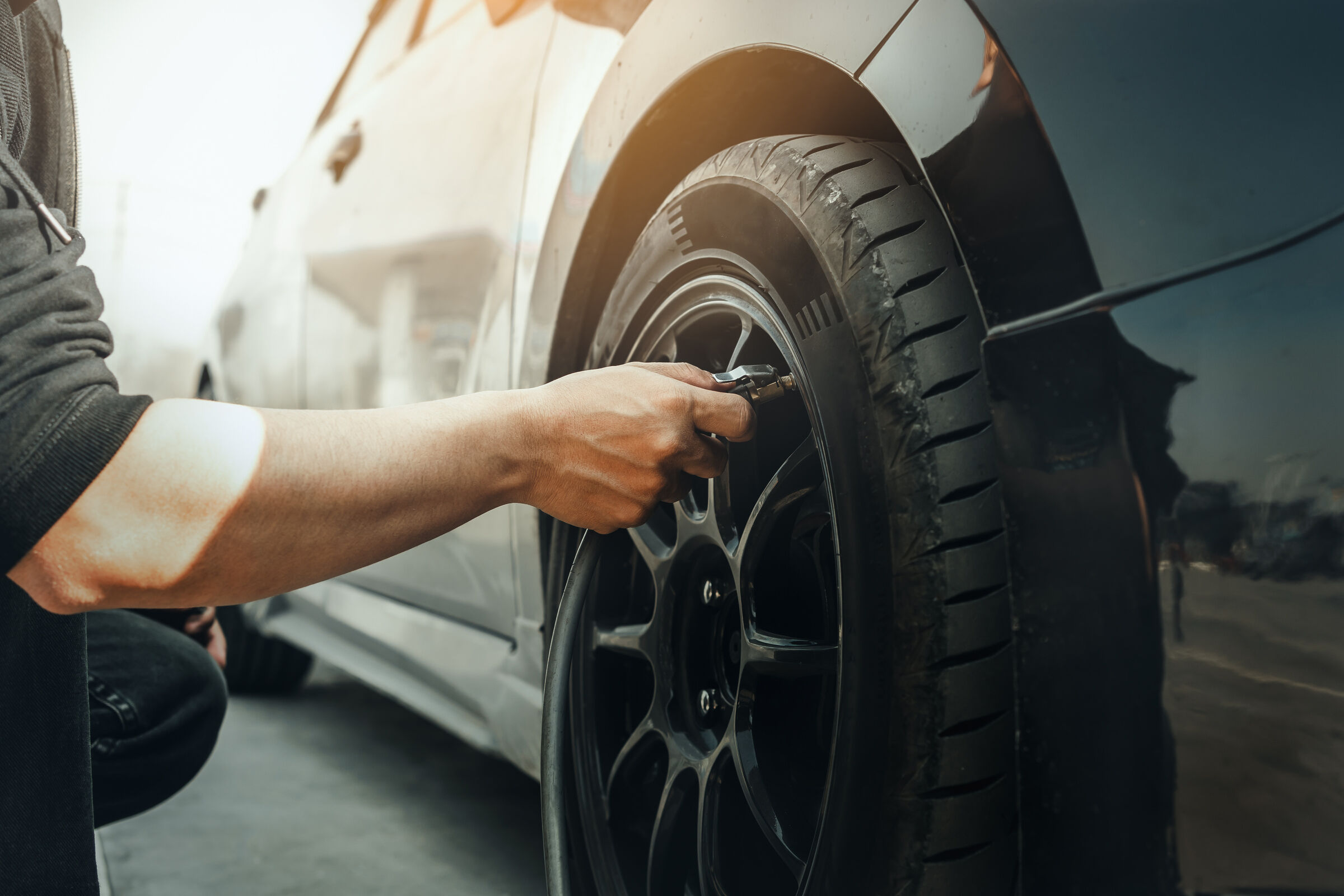 Hand Inflating Tires of Vehicle Checking Air Pressure and Filling